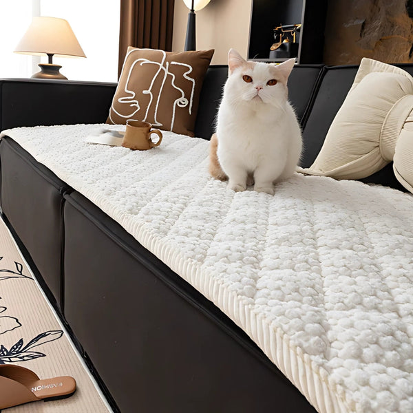 Knit non-slip sofa cover draped over a sofa
