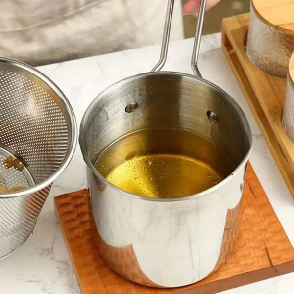 Fryer pot with strainer on a plain background