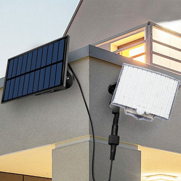 Solar light mounted on a house wall with a separate solar panel.