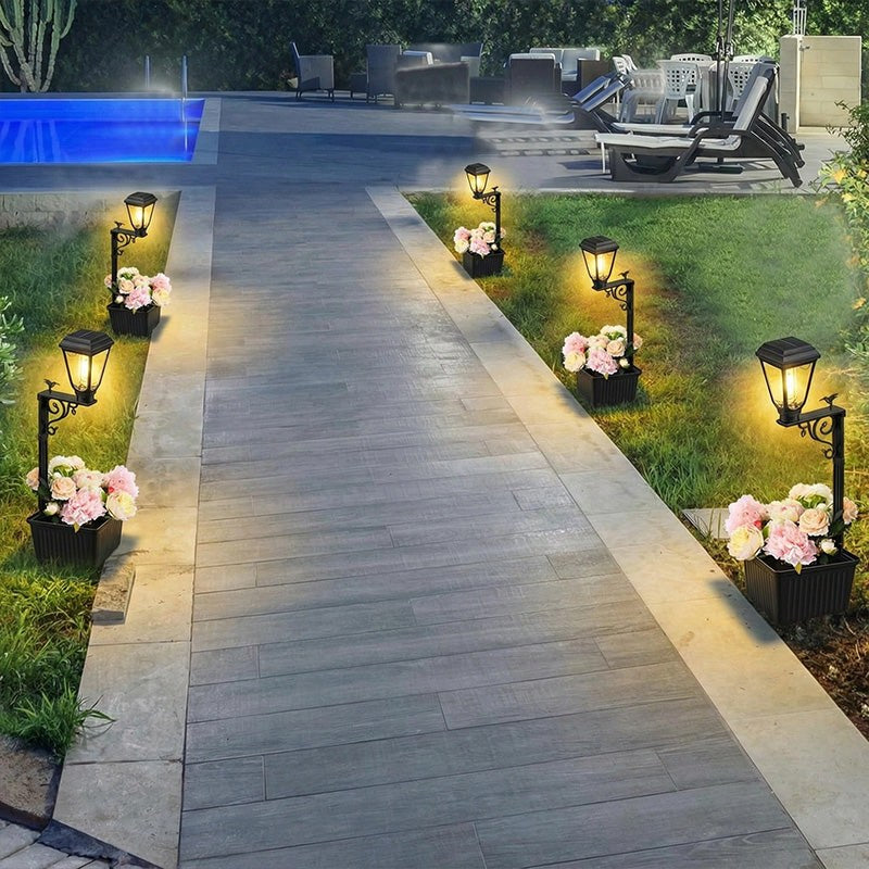 Solar lamp lighting a garden pathway at dusk