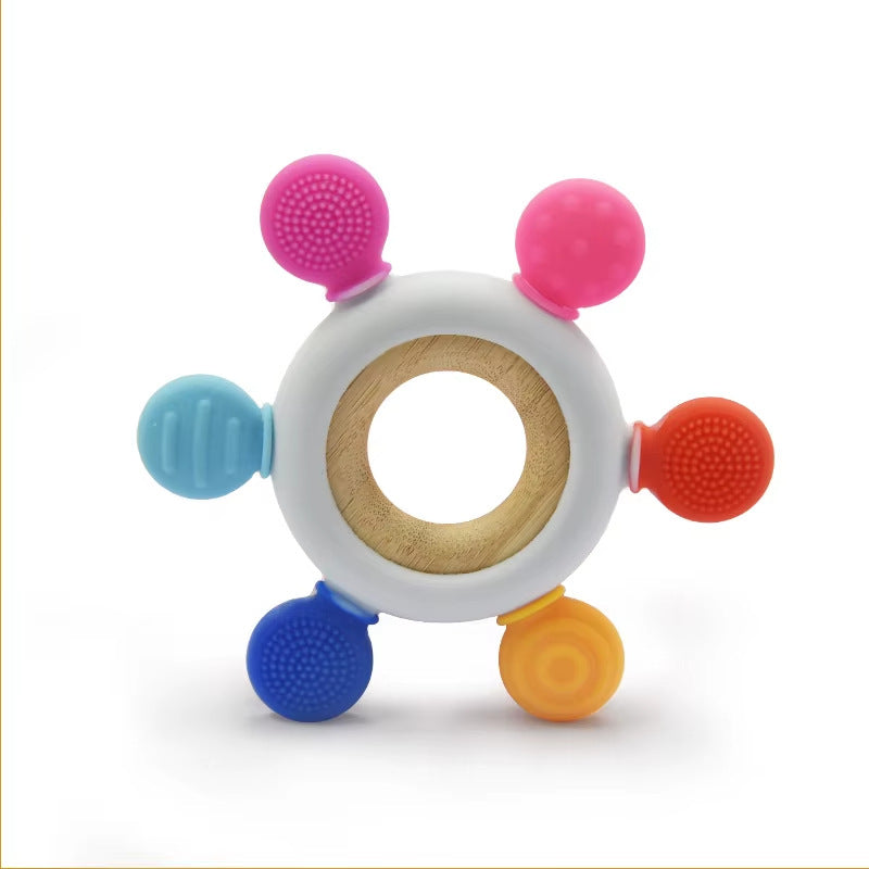 Teething ring resting on a soft blanket.