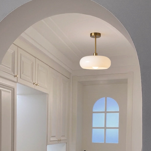 Round ceiling light illuminating a reading nook