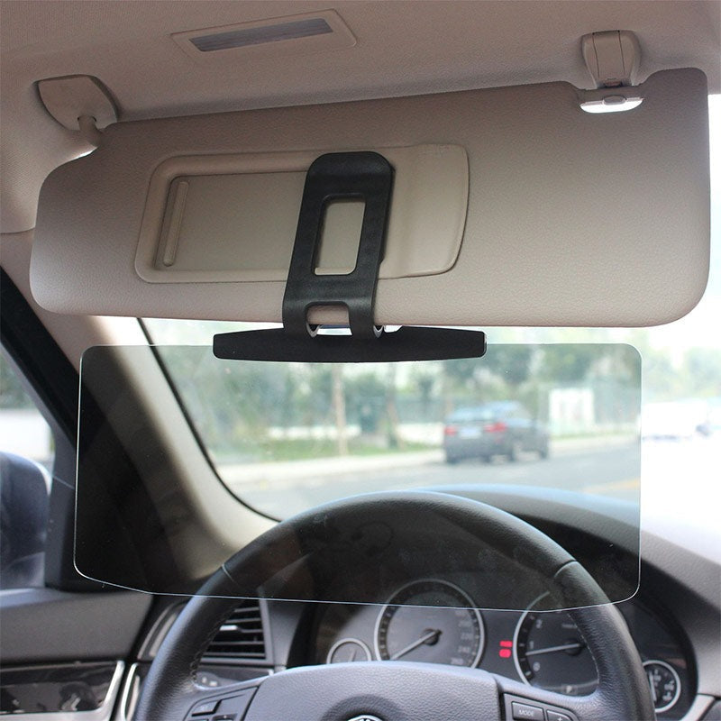 Anti-glare visor mounting clip attached to a car sun visor