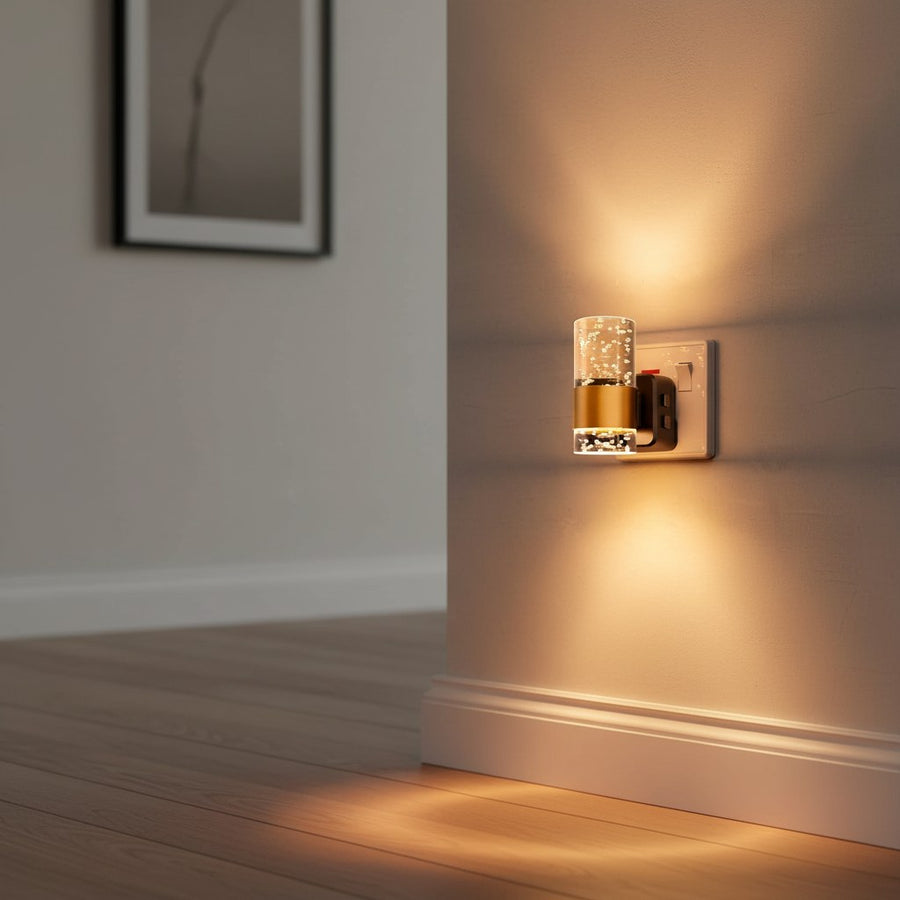 Acrylic night light with brushed gold finish plugged into an outlet