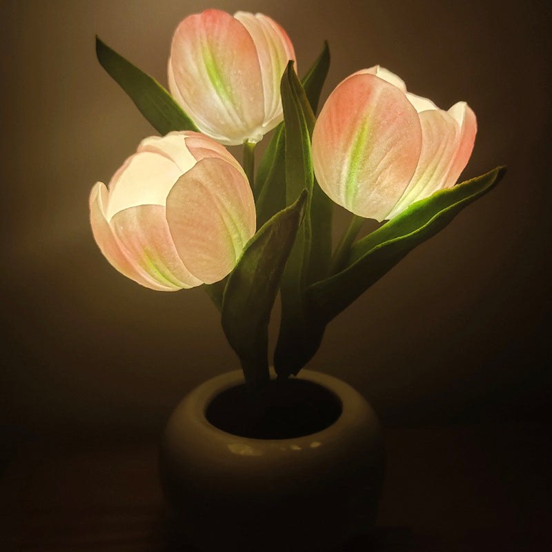 Tulip lamp shown next to a bed for scale