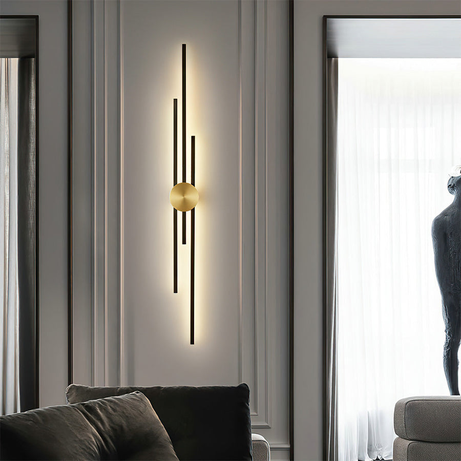 Wall sconce glowing with warm light in a living room setting