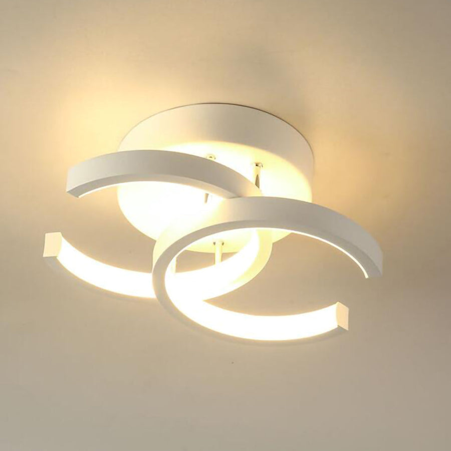 Modern geometric LED ceiling light lit at night