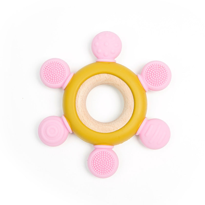 Infant chewing on the soft silicone part of the teething ring.