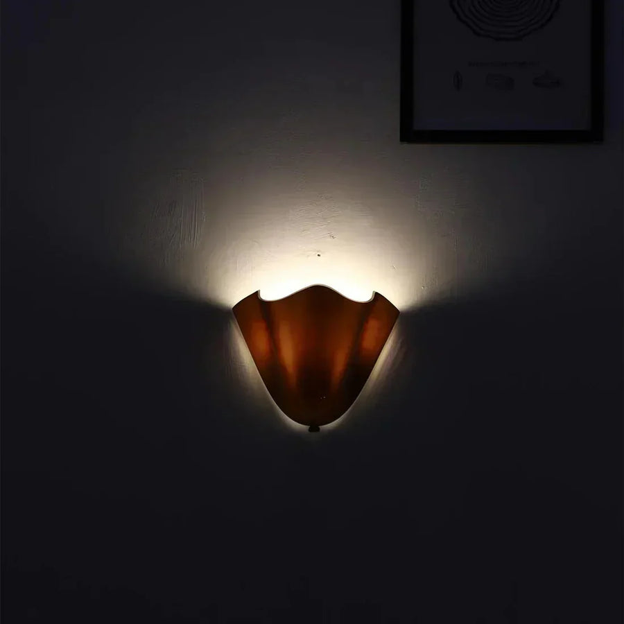 Wall lamp installed above a bed for ambient lighting