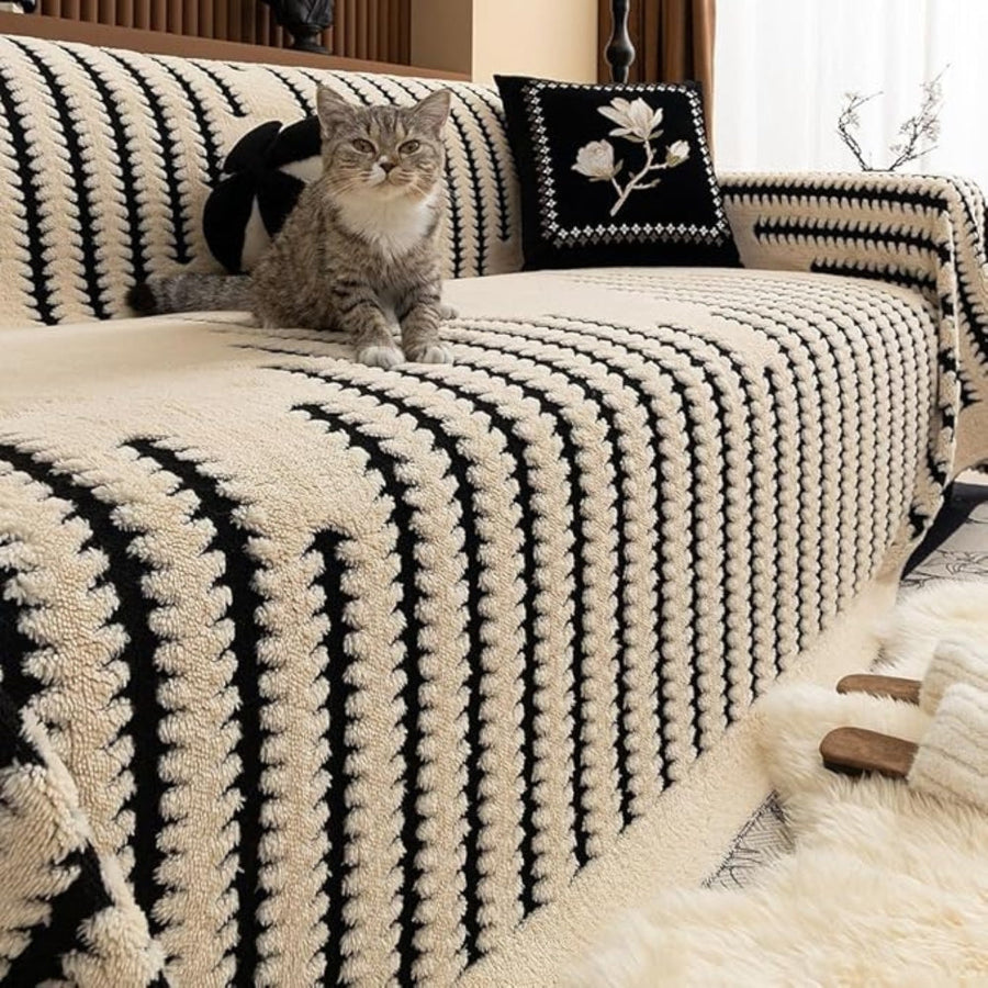 Decorative knit sofa cover draped over a couch