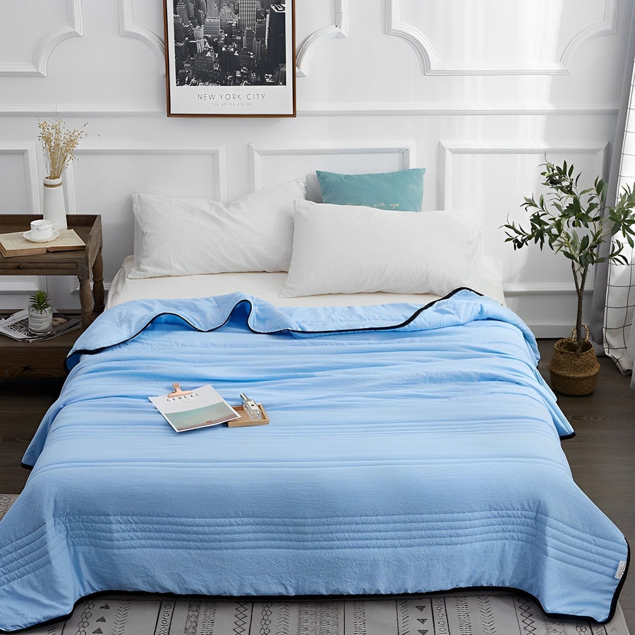 Cooling blanket folded neatly on a couch