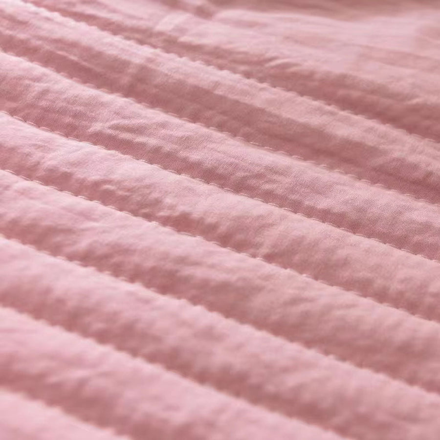 Cooling blanket folded neatly on a bed