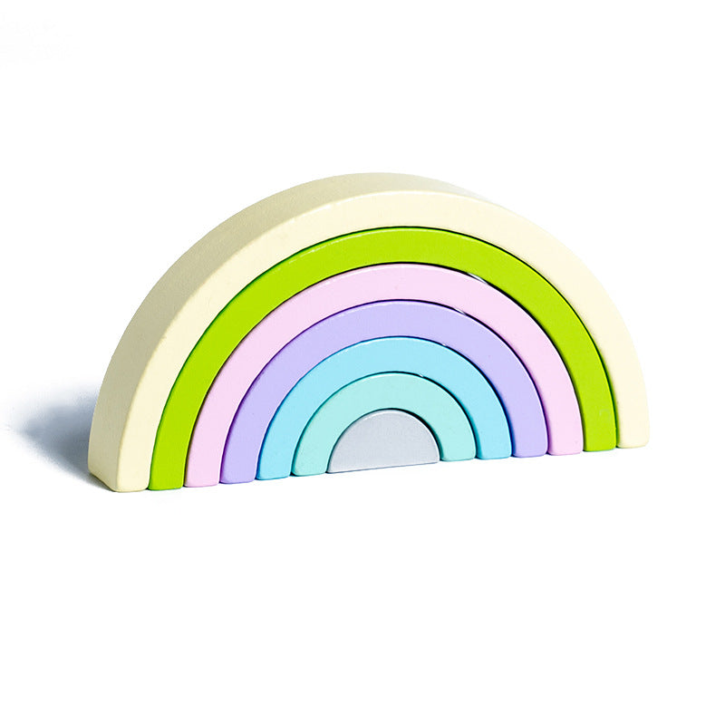Rainbow toy arranged in a bridge shape for balance play.