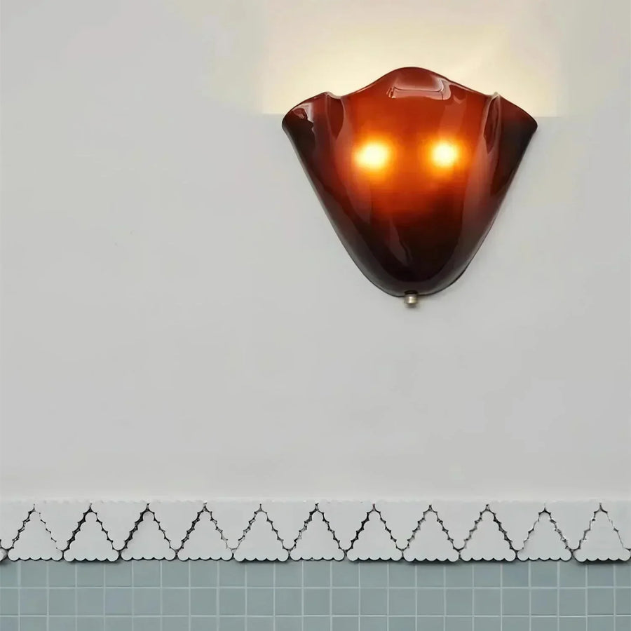 Wall lamp glowing with warm white light in a hallway