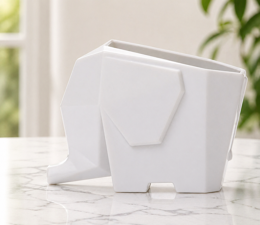 Elephant drainer filled with silverware on a countertop.