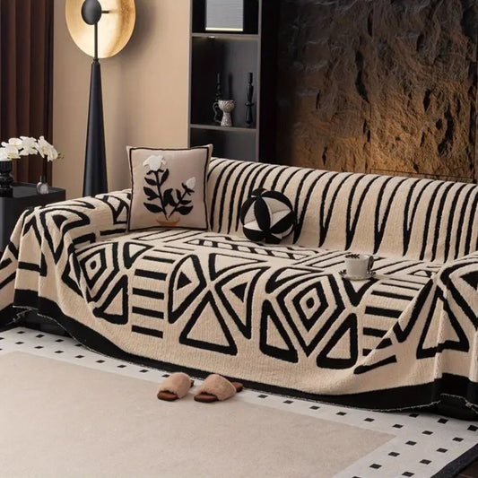 Knit sofa cover with maze pattern draped over a sofa