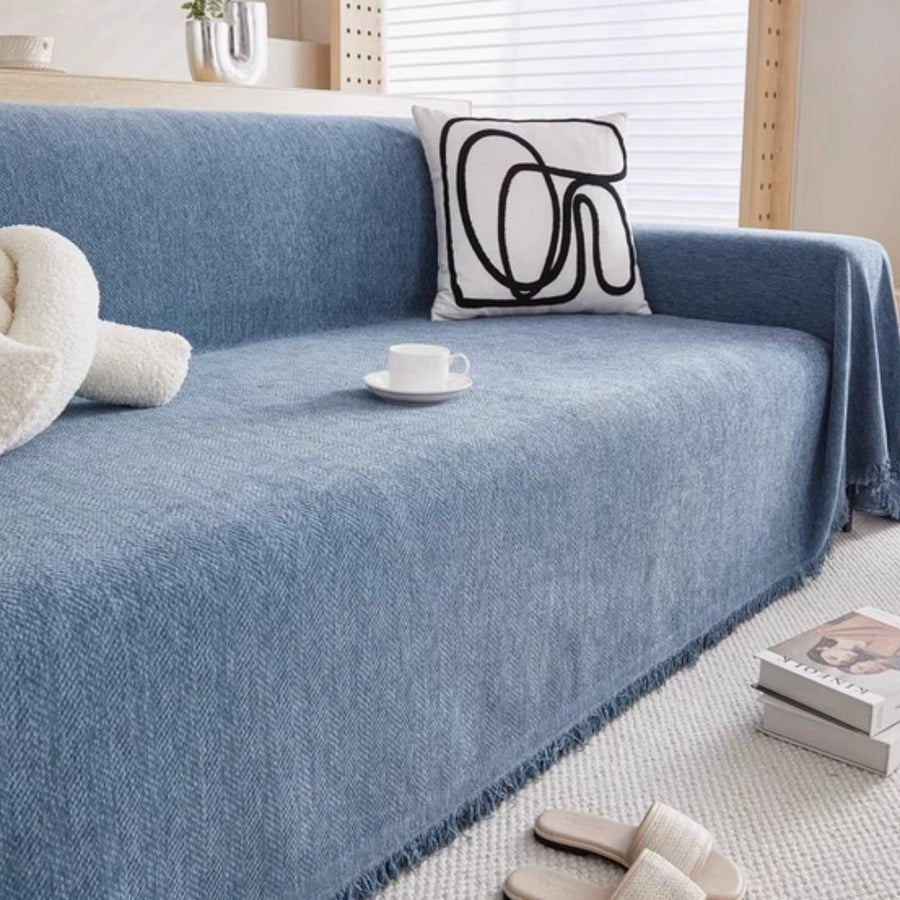 Sofa cover in gray shown covering a full-size sofa