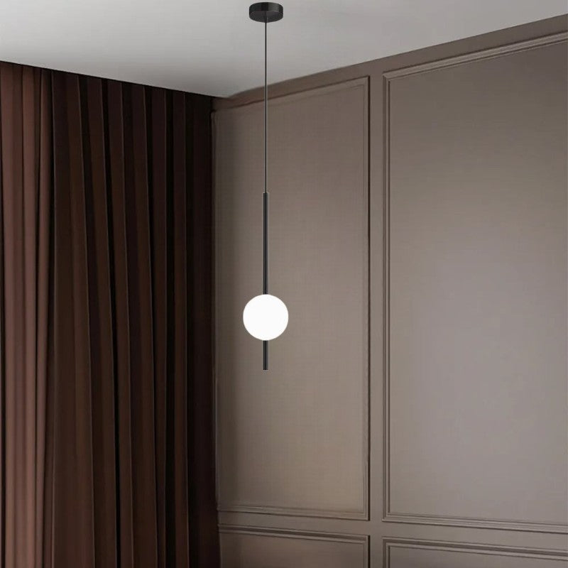 Black globe pendant light with warm white glow