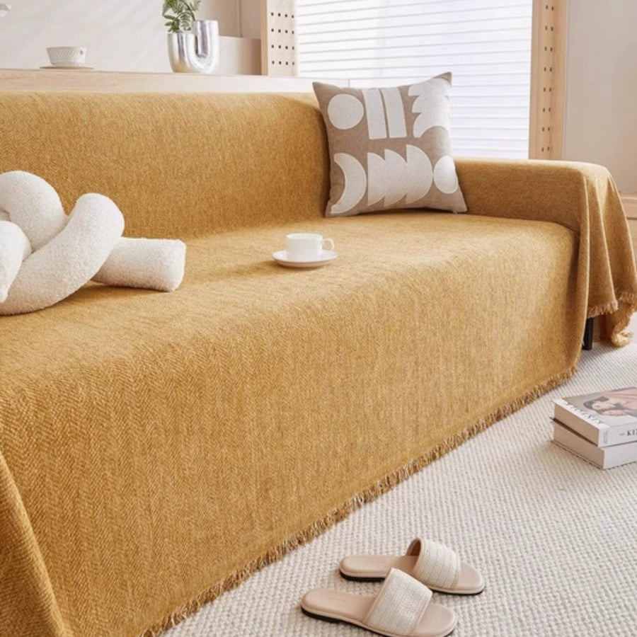 Sofa cover in green fitted neatly over sofa cushions