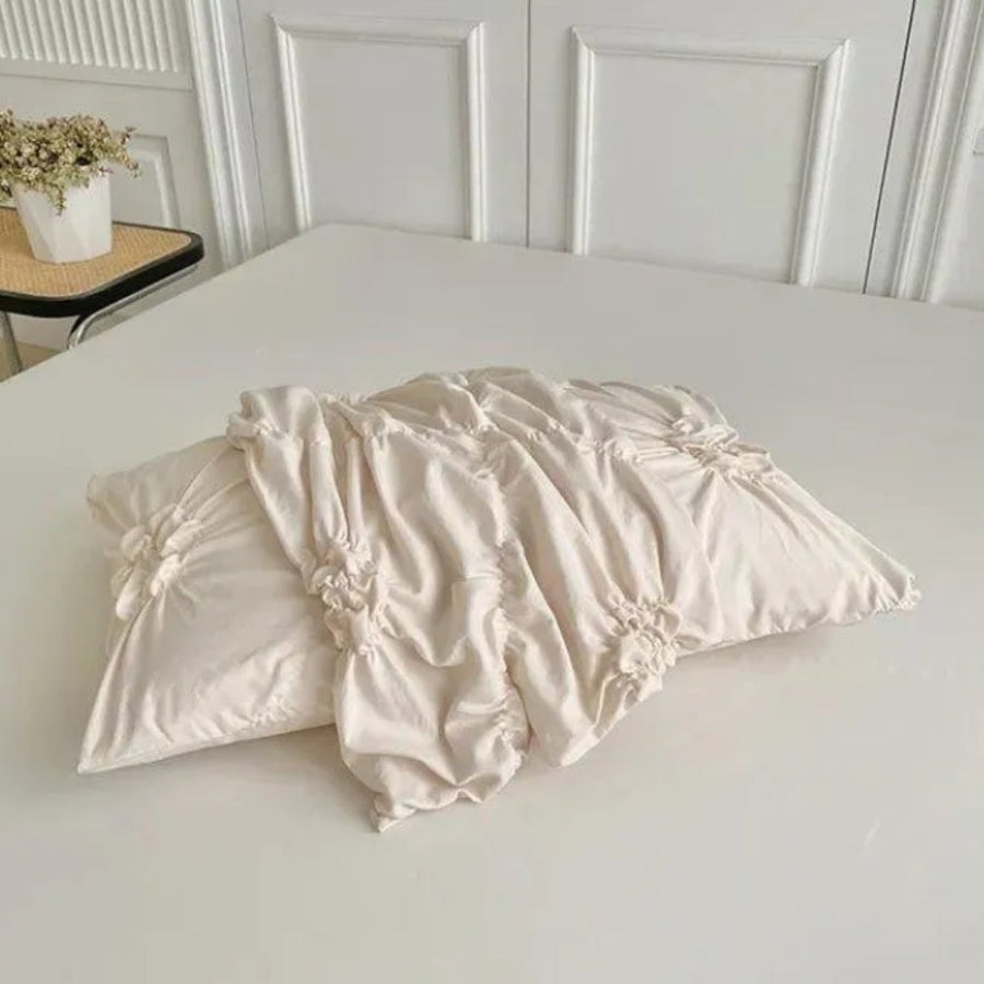 Textured floral duvet cover set draped over a sofa