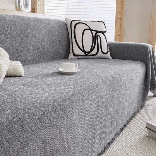 Textured minimalist sofa cover draped over a sofa in a living room