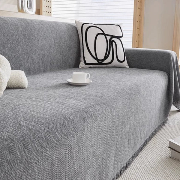 Textured minimalist sofa cover draped over a sofa in a living room