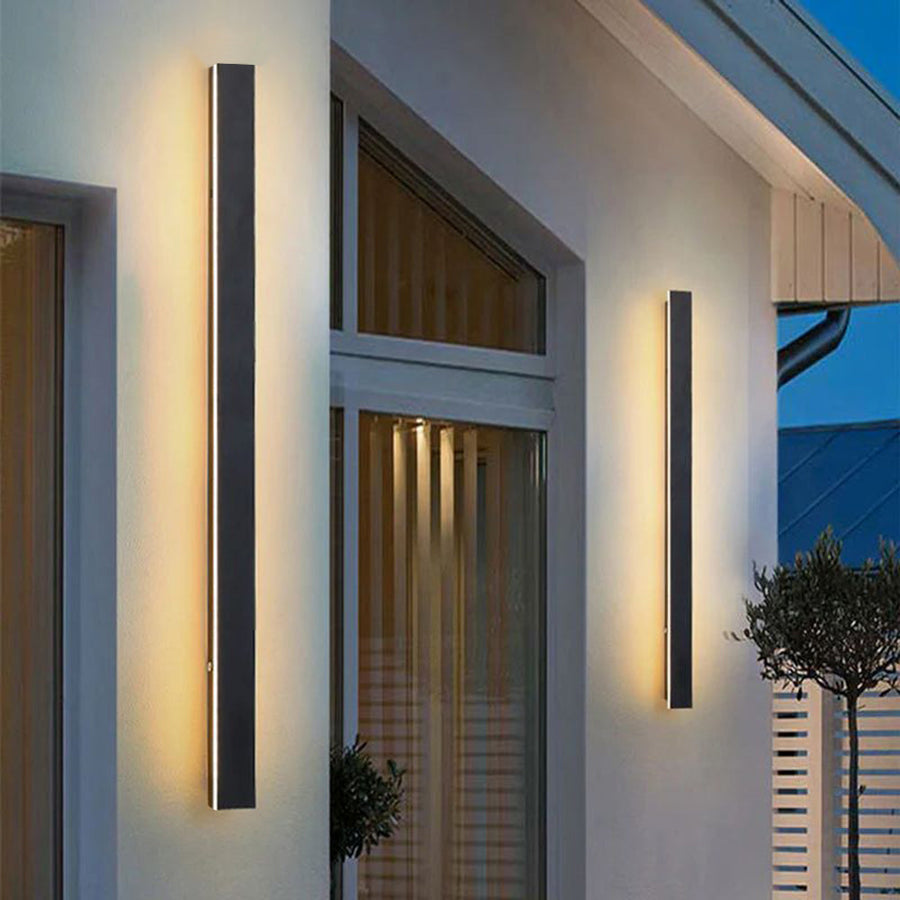 Wall light with warm white light in a garden setting