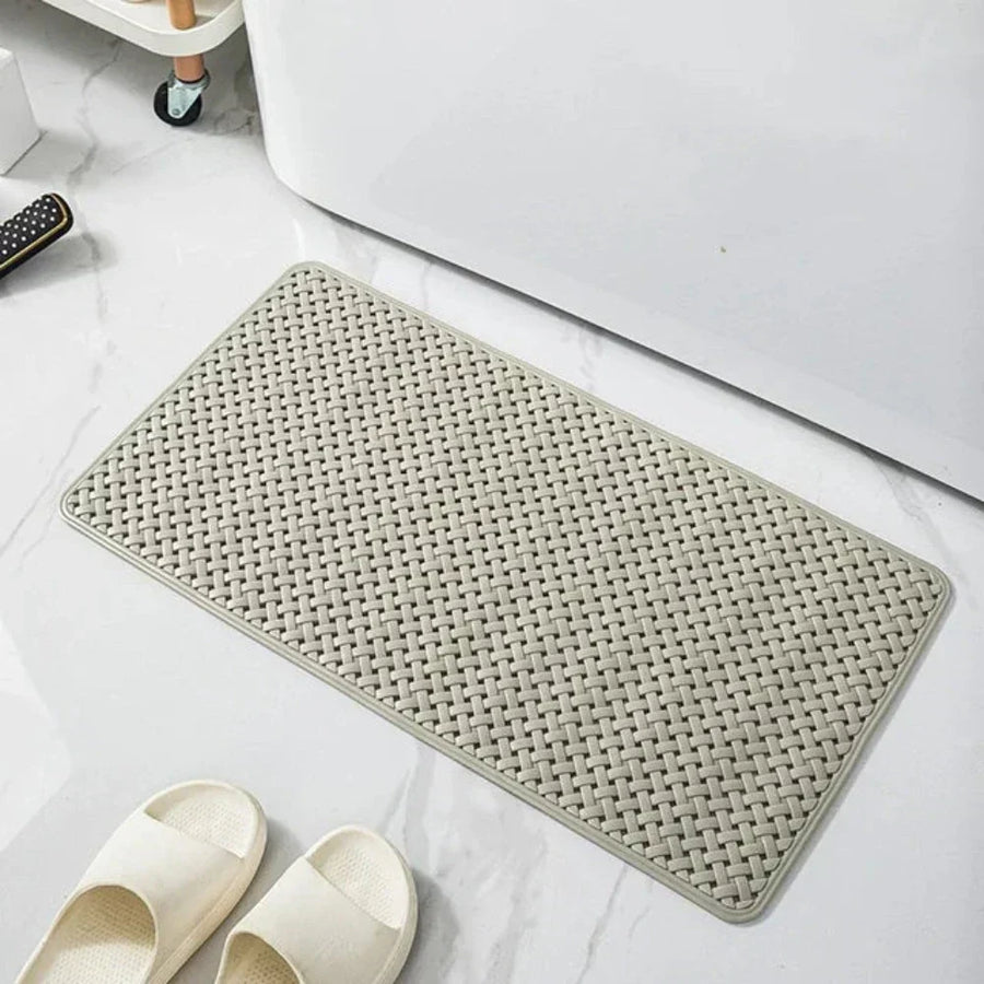 Rolled-up non-slip shower mat showing its flexible material