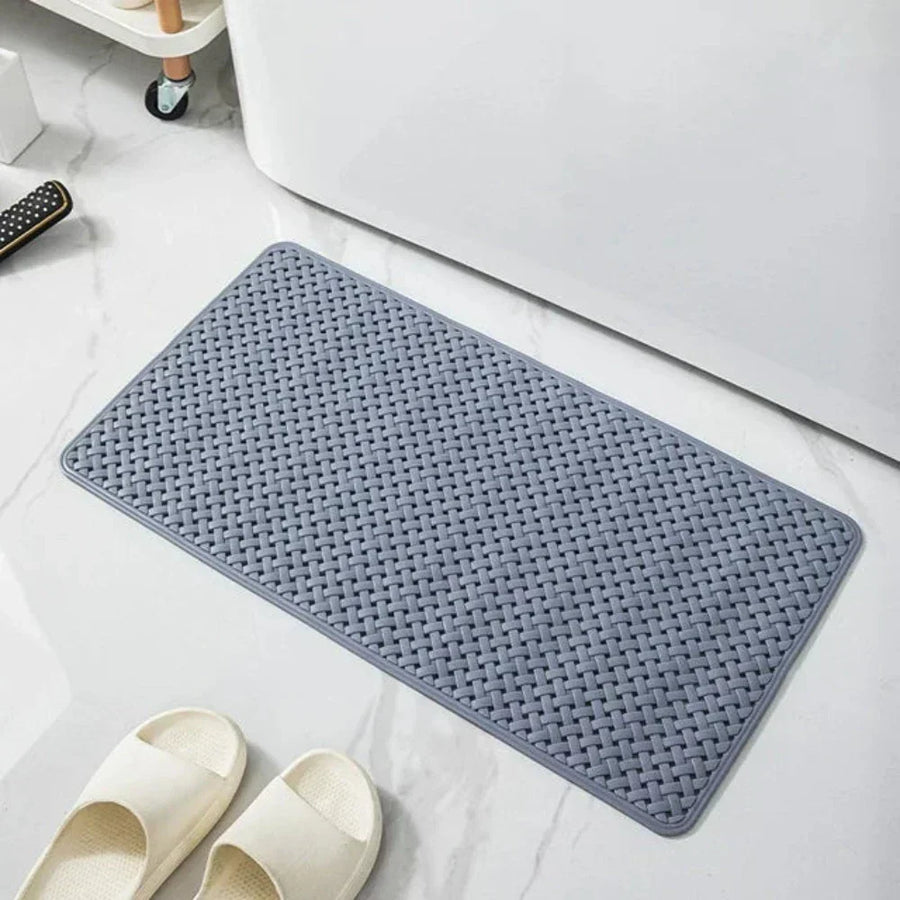Shower mat in dark gray color placed on tile flooring