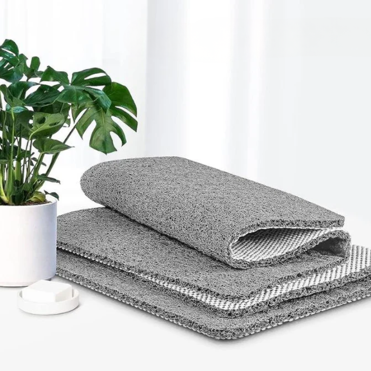 White shower mat shown from above on tile flooring