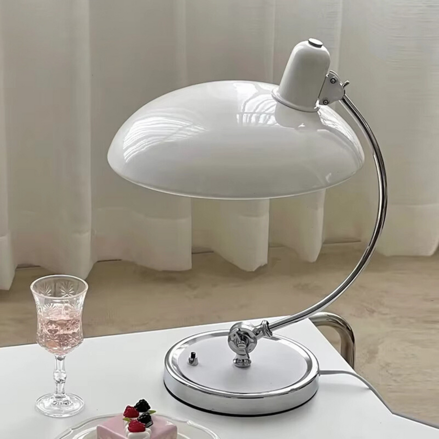 Lamp positioned on a work desk beside a laptop