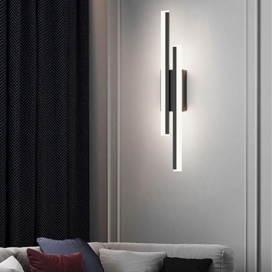 Linear LED wall sconce installed above a nightstand