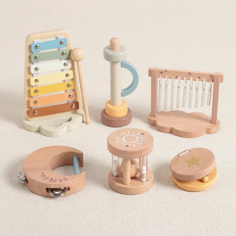 Wooden baby toy set displayed on a soft surface