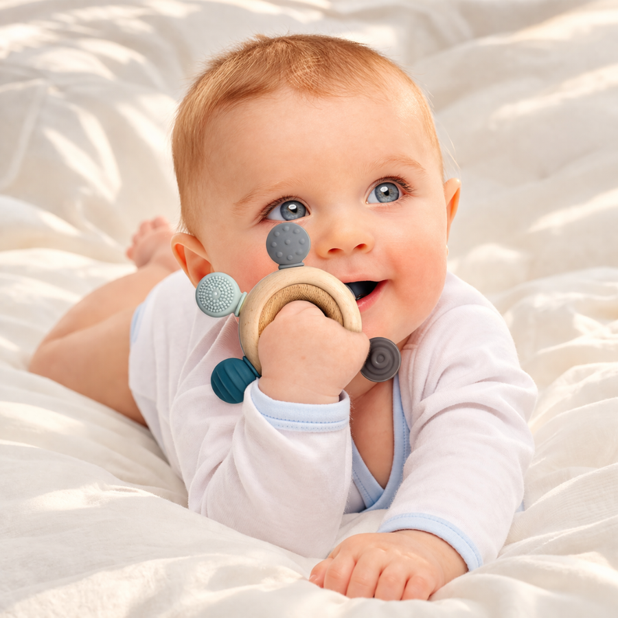 Teething ring shown next to a small wooden ring for scale.