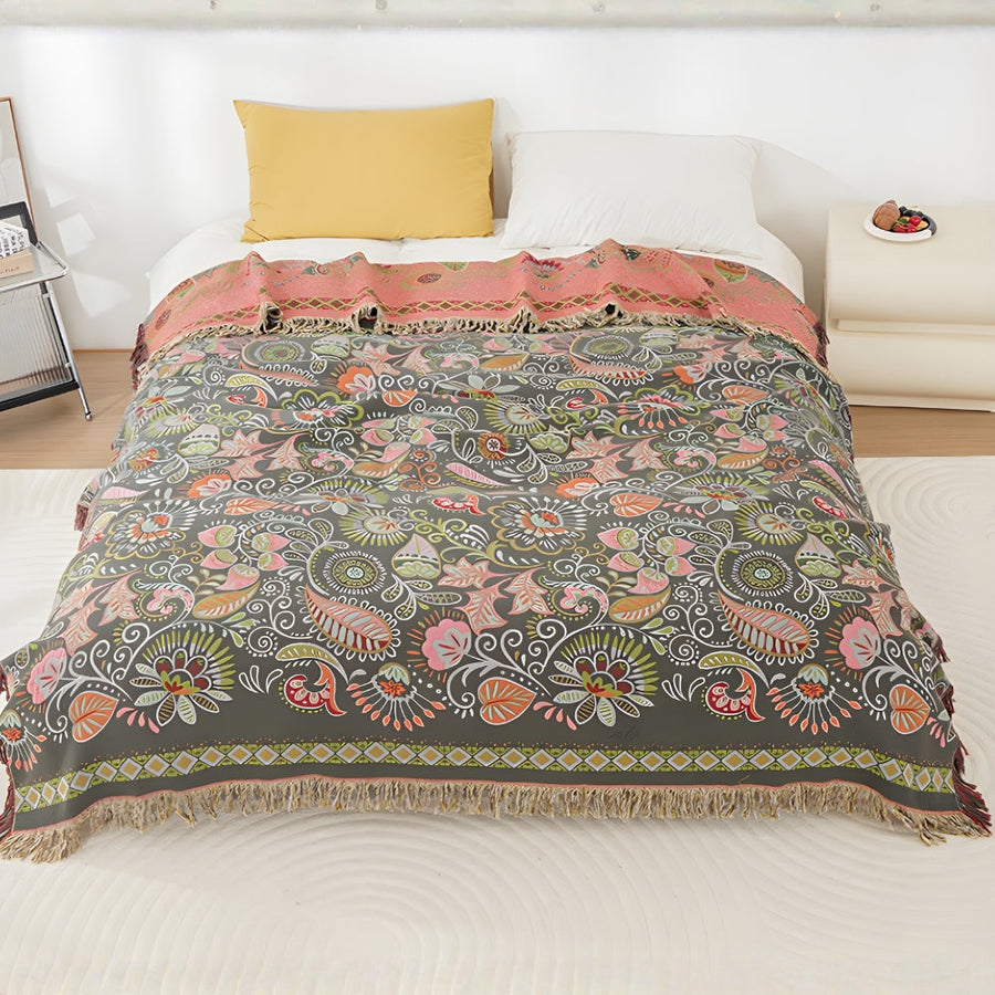 Washable boho throw blanket folded on a bed