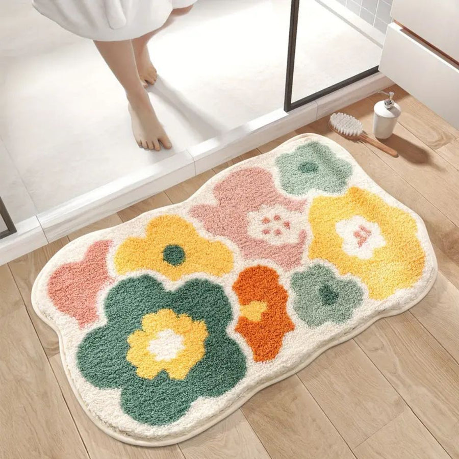 Non-slip floral bath mat laid on a bathroom floor