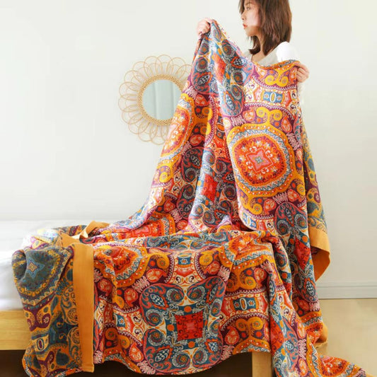 Reversible boho throw blanket draped over a couch