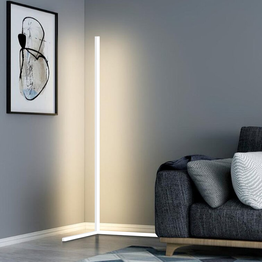 White corner floor lamp next to a sofa