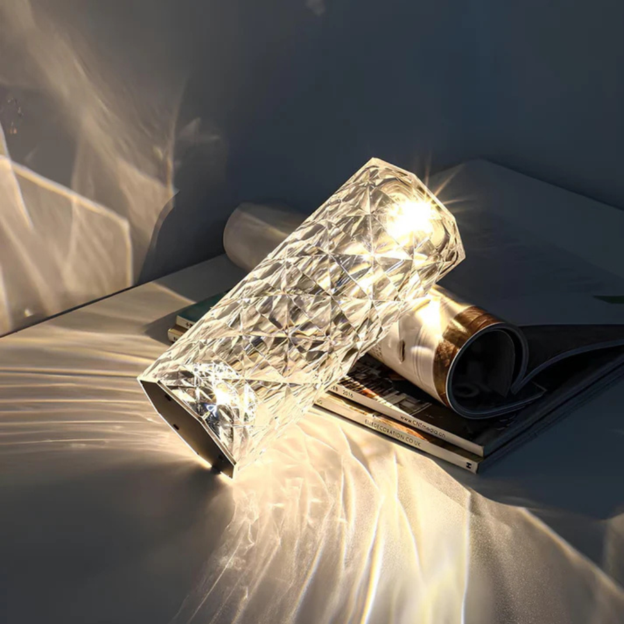Crystalglow lamp placed on a nightstand beside a bed