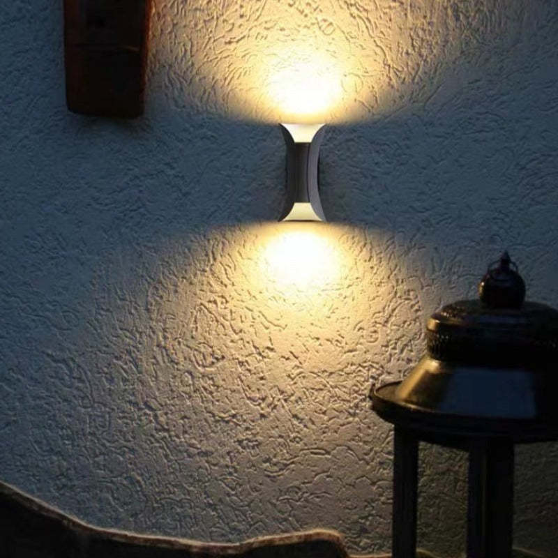 Modern wall light installed near a front entryway