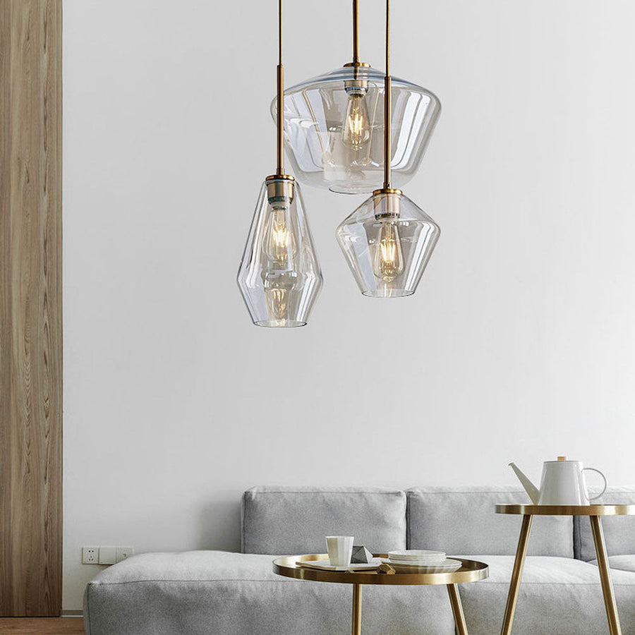 Modern industrial pendant light with geometric shade hanging over a table