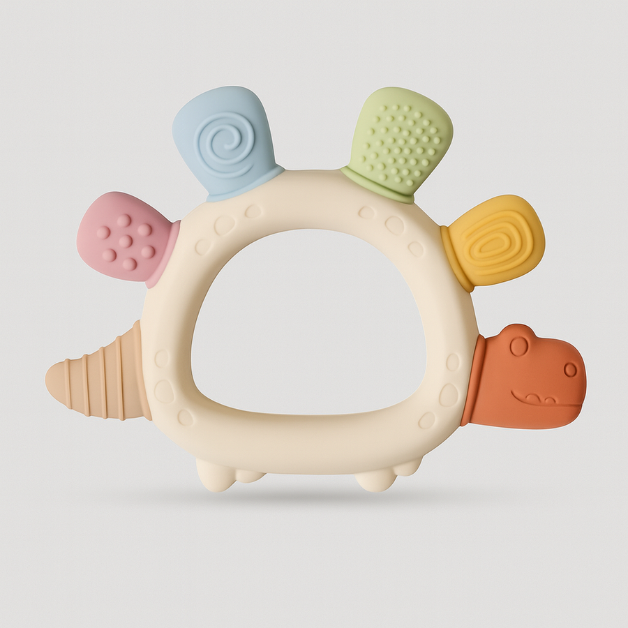Dinosaur-shaped silicone teething ring with pastel textured bumps.