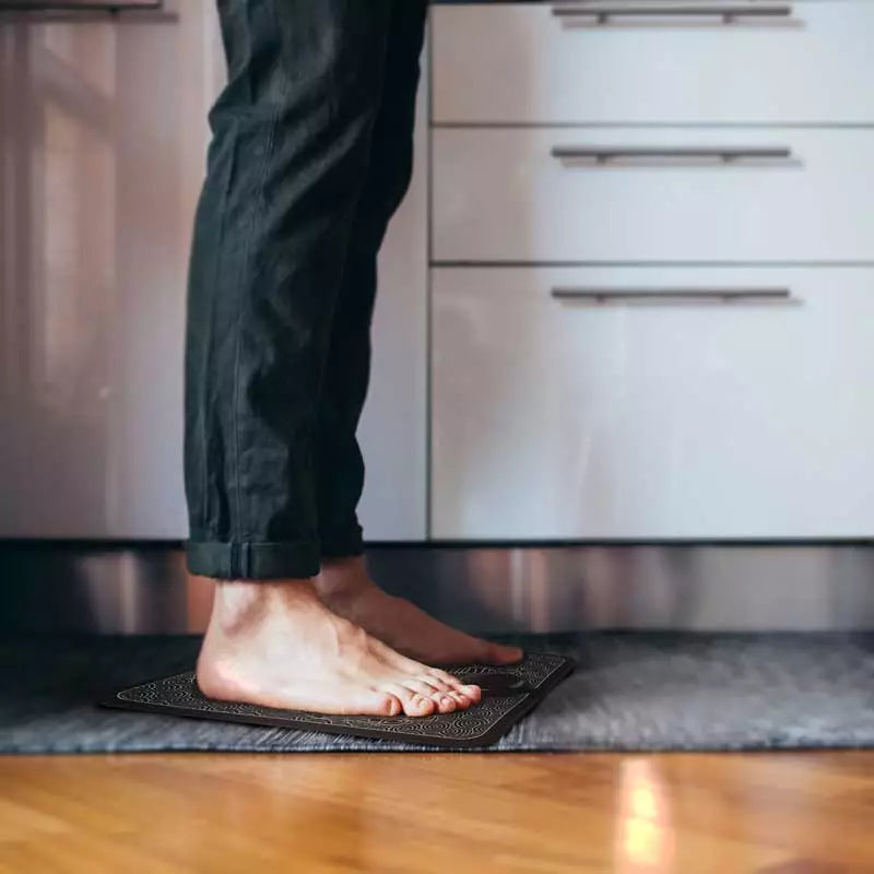 Close-up of the EMS foot massage mat's acupoint design