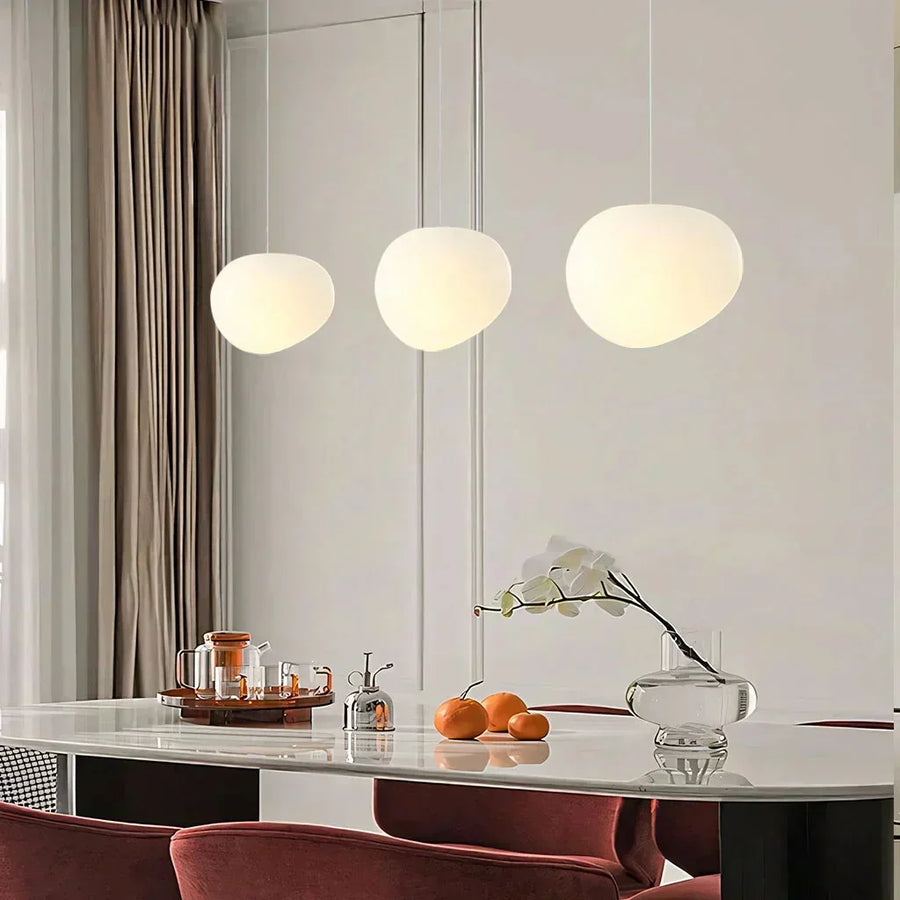 Modern white Pebble pendant light over a dining table