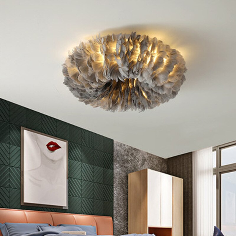 Boho LED ceiling lamp with feathers lit in a living room