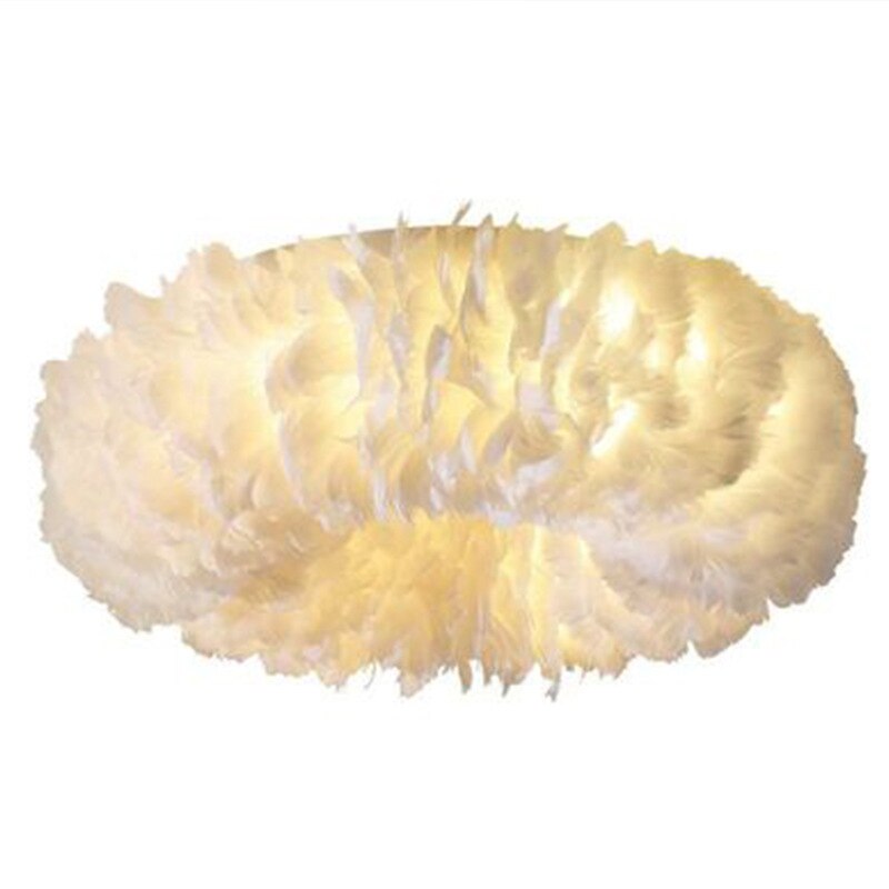 Boho LED ceiling lamp with feathers styled in a cozy room