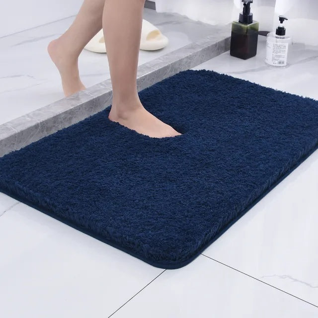 Pink bath mat next to a bathtub
