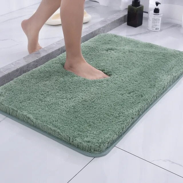Green bath mat placed in front of a sink