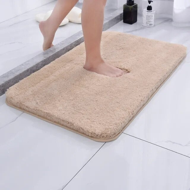Beige bath mat rolled up to show thickness
