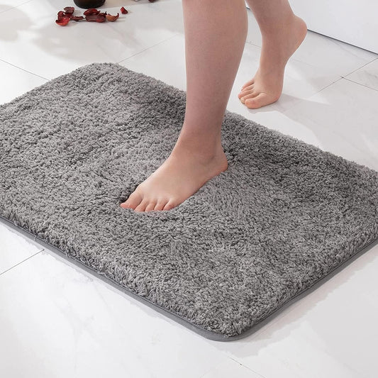 Soft blue bath mat on a bathroom floor